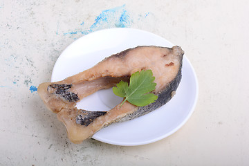 Image showing Frying pan with one roasted salmon steaks, view from above