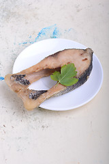 Image showing Frying pan with one roasted salmon steaks, view from above