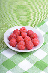 Image showing Fresh raspberries. Closeup of fruits on a white plate