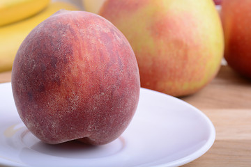 Image showing peach,  apple and strawberry on wooden plate 