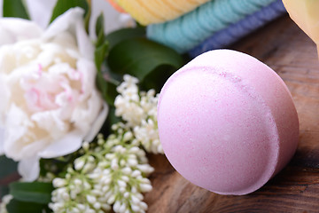 Image showing towels, aroma spa, flower and sea salt on wooden plate 