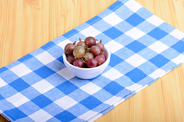 Image showing Green gooseberries on white plate