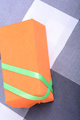 Image showing orange gift box with green ribbon