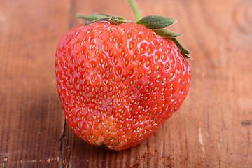 Image showing Strawberry on wooden plate close up