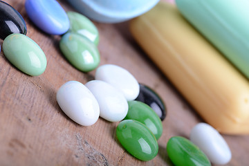 Image showing Beautiful spa setting with stone set, soap and sea salt on wooden table close up