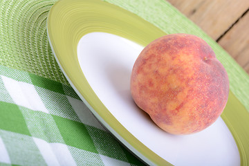 Image showing fresh peaches on green plate, food concept