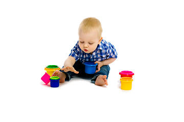 Image showing baby boy on a white floor with toys