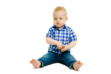 Image showing boy sitting on a white floor