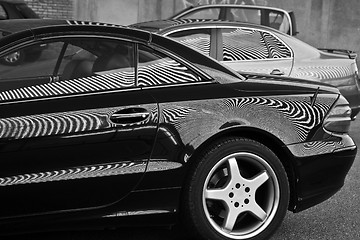 Image showing Car and stripes, car parked in front of a building with striped 