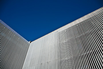 Image showing Car and stripes, car parked in front of a building with striped 