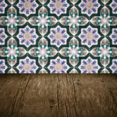 Image showing Wood table top and blur vintage ceramic tile pattern wall