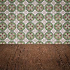 Image showing Wood table top and blur vintage ceramic tile pattern wall