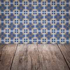 Image showing Wood table top and blur vintage ceramic tile pattern wall