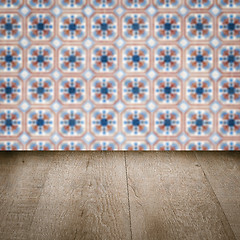 Image showing Wood table top and blur vintage ceramic tile pattern wall