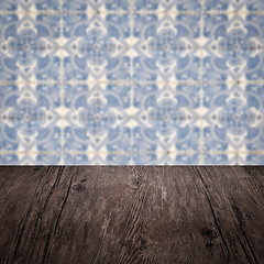 Image showing Wood table top and blur vintage ceramic tile pattern wall