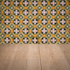 Image showing Wood table top and blur vintage ceramic tile pattern wall