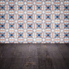 Image showing Wood table top and blur vintage ceramic tile pattern wall