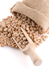 Image showing Uncooked chickpeas and wooden scoop