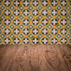 Image showing Wood table top and blur vintage ceramic tile pattern wall