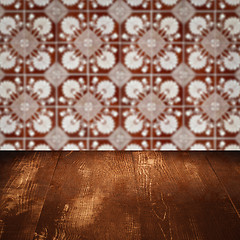 Image showing Wood table top and blur vintage ceramic tile pattern wall