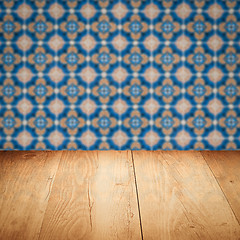 Image showing Wood table top and blur vintage ceramic tile pattern wall