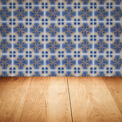 Image showing Wood table top and blur vintage ceramic tile pattern wall