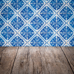 Image showing Wood table top and blur vintage ceramic tile pattern wall