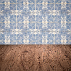 Image showing Wood table top and blur vintage ceramic tile pattern wall