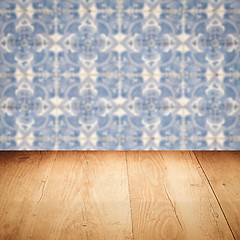 Image showing Wood table top and blur vintage ceramic tile pattern wall