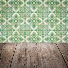 Image showing Wood table top and blur vintage ceramic tile pattern wall