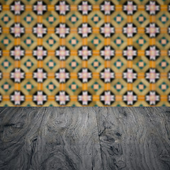 Image showing Wood table top and blur vintage ceramic tile pattern wall