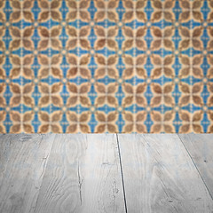 Image showing Wood table top and blur vintage ceramic tile pattern wall