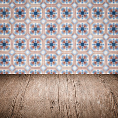 Image showing Wood table top and blur vintage ceramic tile pattern wall