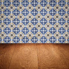 Image showing Wood table top and blur vintage ceramic tile pattern wall