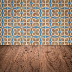 Image showing Wood table top and blur vintage ceramic tile pattern wall