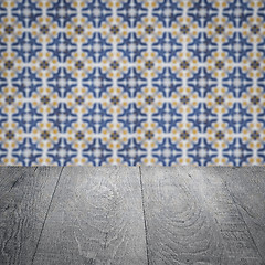 Image showing Wood table top and blur vintage ceramic tile pattern wall