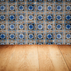 Image showing Wood table top and blur vintage ceramic tile pattern wall