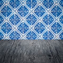 Image showing Wood table top and blur vintage ceramic tile pattern wall