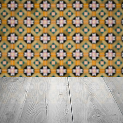 Image showing Wood table top and blur vintage ceramic tile pattern wall