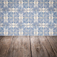 Image showing Wood table top and blur vintage ceramic tile pattern wall