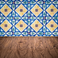 Image showing Wood table top and blur vintage ceramic tile pattern wall