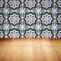 Image showing Wood table top and blur vintage ceramic tile pattern wall