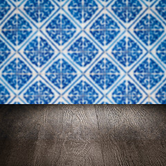 Image showing Wood table top and blur vintage ceramic tile pattern wall