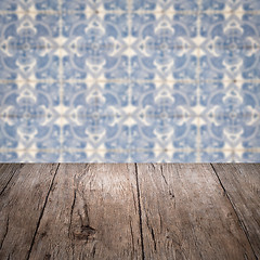 Image showing Wood table top and blur vintage ceramic tile pattern wall