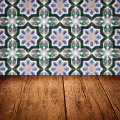 Image showing Wood table top and blur vintage ceramic tile pattern wall