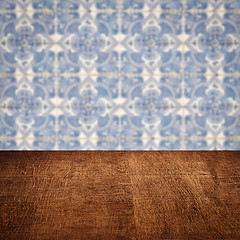 Image showing Wood table top and blur vintage ceramic tile pattern wall