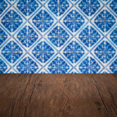 Image showing Wood table top and blur vintage ceramic tile pattern wall