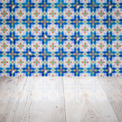 Image showing Wood table top and blur vintage ceramic tile pattern wall