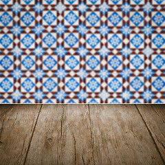 Image showing Wood table top and blur vintage ceramic tile pattern wall