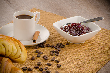 Image showing Cup of black coffee and croissant 